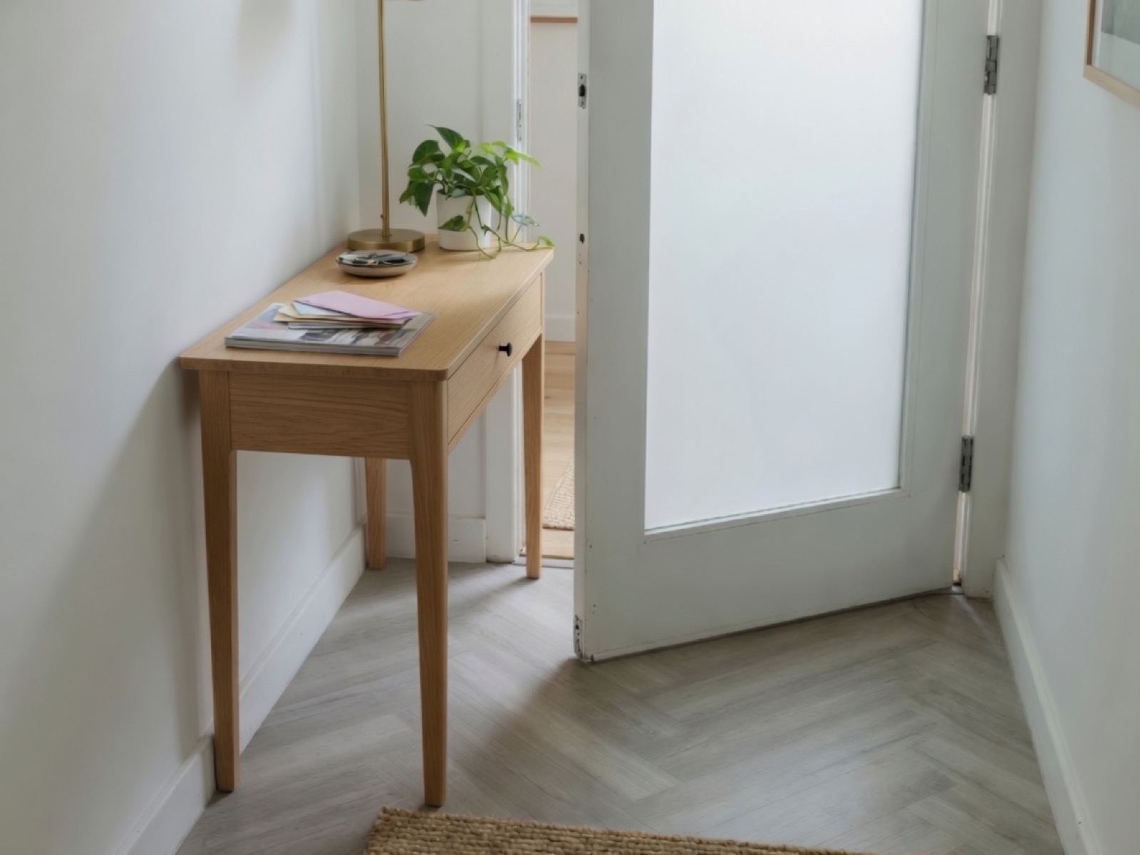 A console table that is too wide for the hallway, so the door cannot close